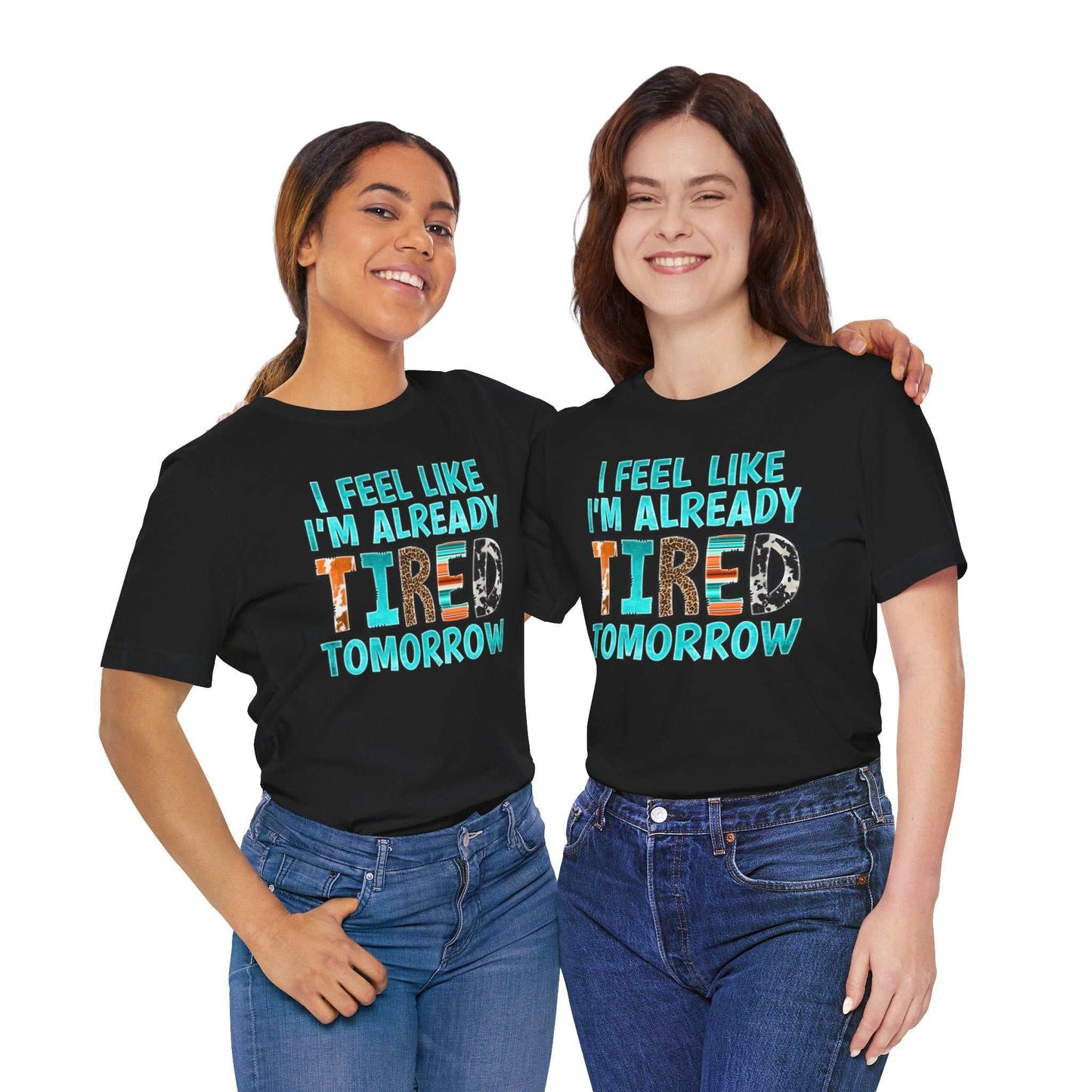 Women wearing "Tired Tomorrow Mental Health Matters" T-shirts, promoting mental health awareness, both smiling.