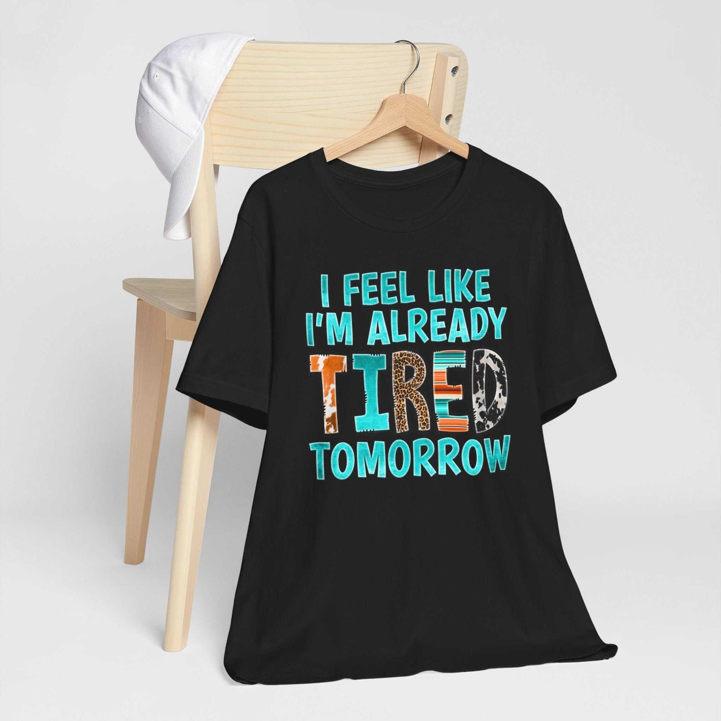 Black t-shirt with "I Feel Like I'm Already Tired Tomorrow" text, promoting mental health awareness.