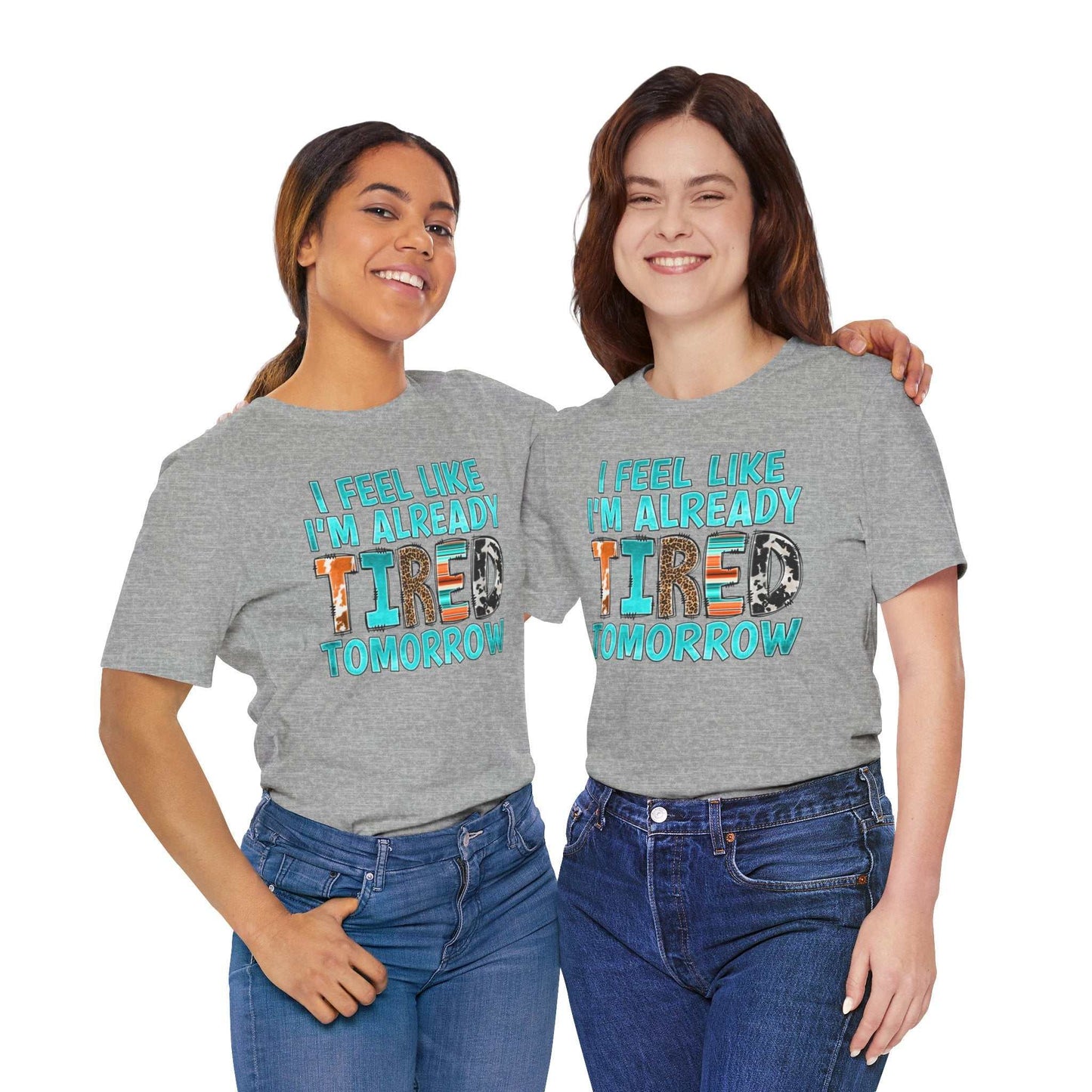 Two people wearing gray T-shirts with the phrase "I Feel Like I'm Already Tired Tomorrow" in colorful letters, advocating mental health awareness.