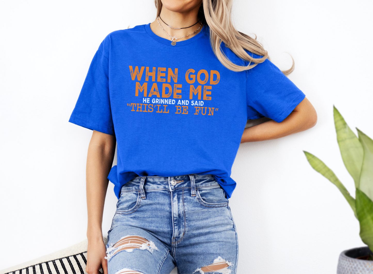 Blue unisex softstyle t-shirt with "When God Made Me" fun religious graphic text, paired with ripped jeans.