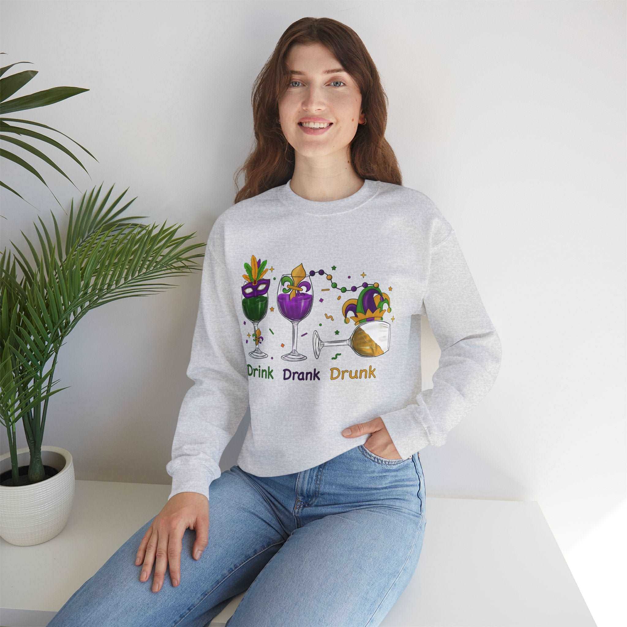 Mardi Gras unisex sweatshirt with "Drink, Drank, Drunk" design on a Gildan 18000, featuring vibrant colors and festive spirit.