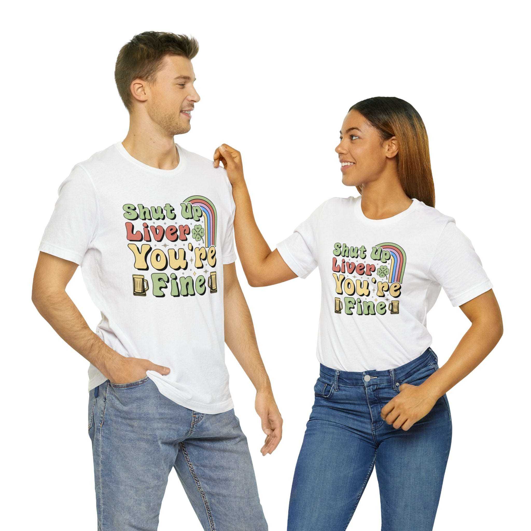 Unisex white "Shut Up Liver You're Fine" St. Patrick's Day t-shirt with colorful print, worn by a man and woman.