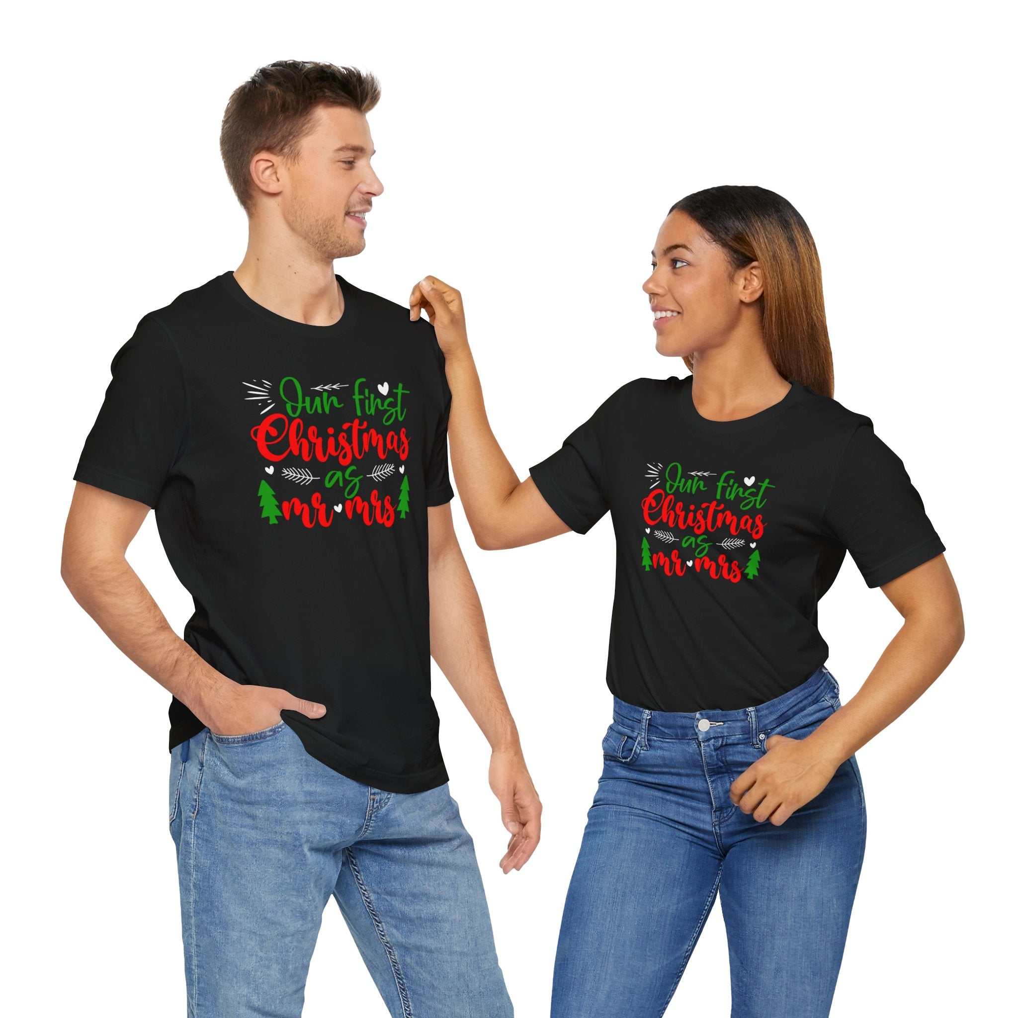 Couple wearing matching "First Christmas Together" shirts, smiling at each other.