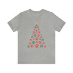 Unisex Holiday T-shirt featuring a Christmas tree made of colorful dog paw prints on a soft Bella Canvas 3001 fabric.