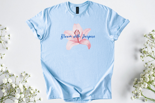 Light blue Gildan Softstyle Unisex Shirt featuring a pink flower and "Bloom with Purpose" motivational text.