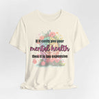White T-shirt with floral design and "If it costs you your mental health, then it is too expensive" slogan.
