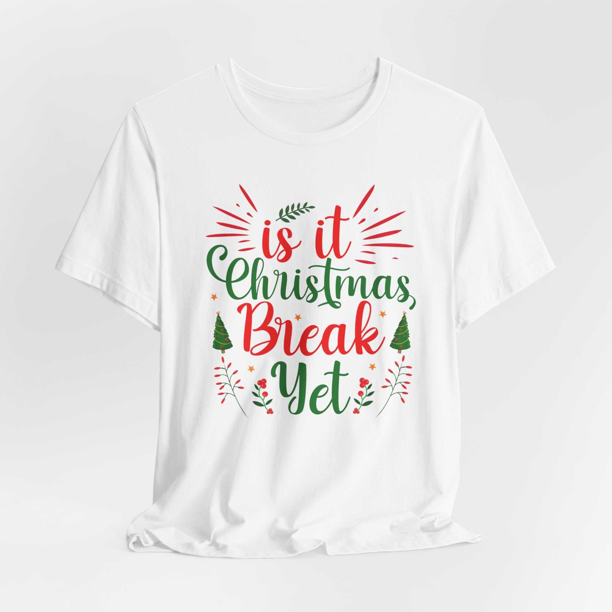 White t-shirt with "Is It Christmas Break Yet?" in festive red and green text, Christmas break theme.
