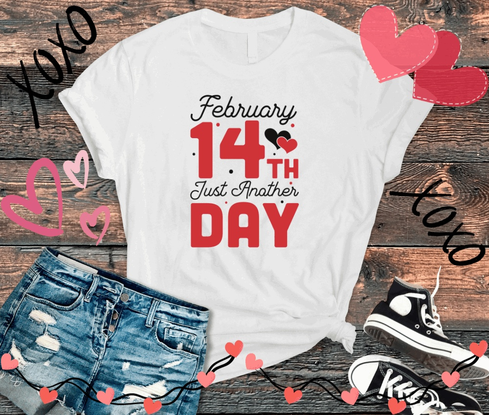 Anti Valentine T-Shirt with "February 14th Is Just Another Day" text, displayed with denim shorts and sneakers.