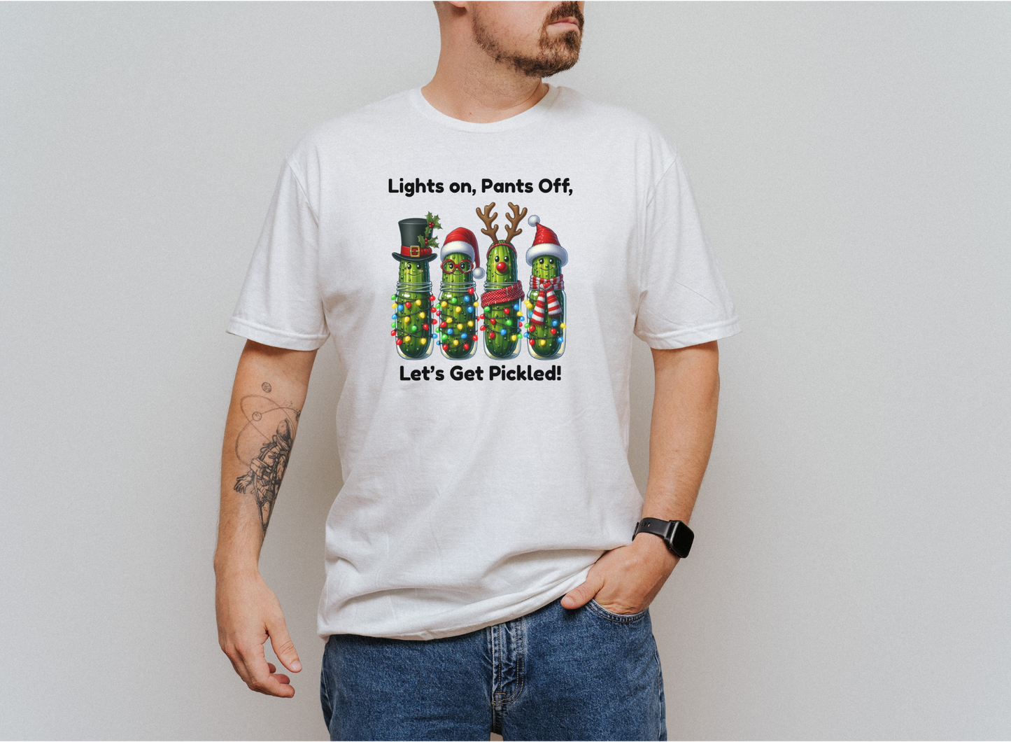 Men's white holiday shirt with festive pickles wrapped in Christmas lights and text "Lights on, Pants Off, Let's Get Pickled"