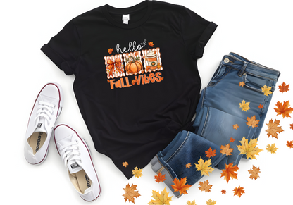 Black Hello Fall Vibes softstyle shirt with pumpkins and coffee design, paired with jeans and white sneakers surrounded by autumn leaves