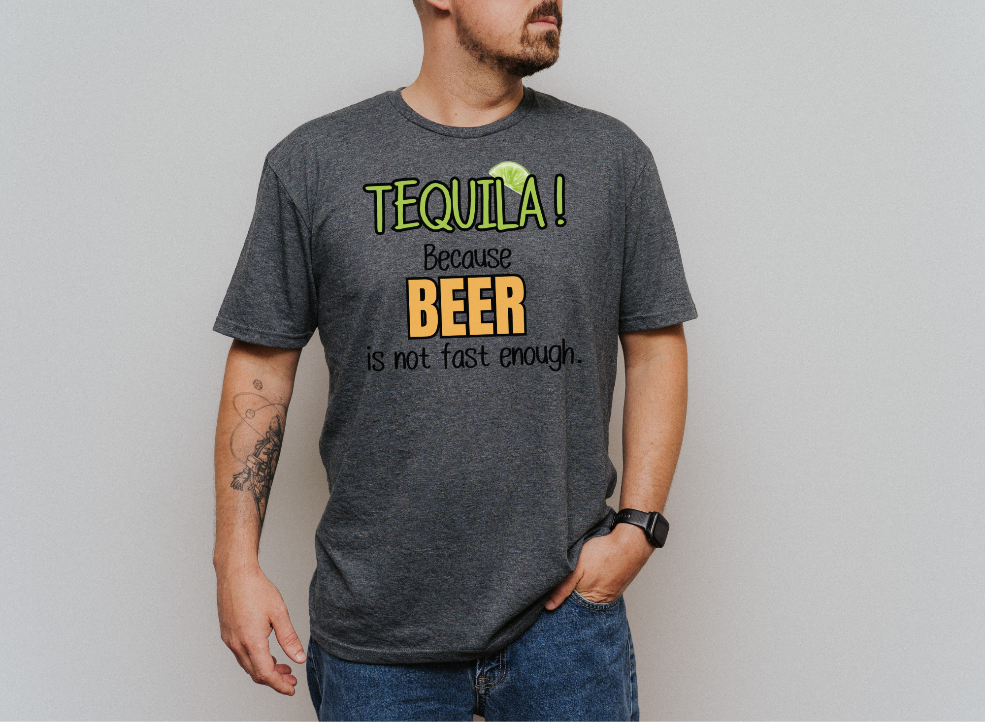 Unisex softstyle shirt with "TEQUILA! Because Beer is not Fast Enough" graphic, worn by a man.