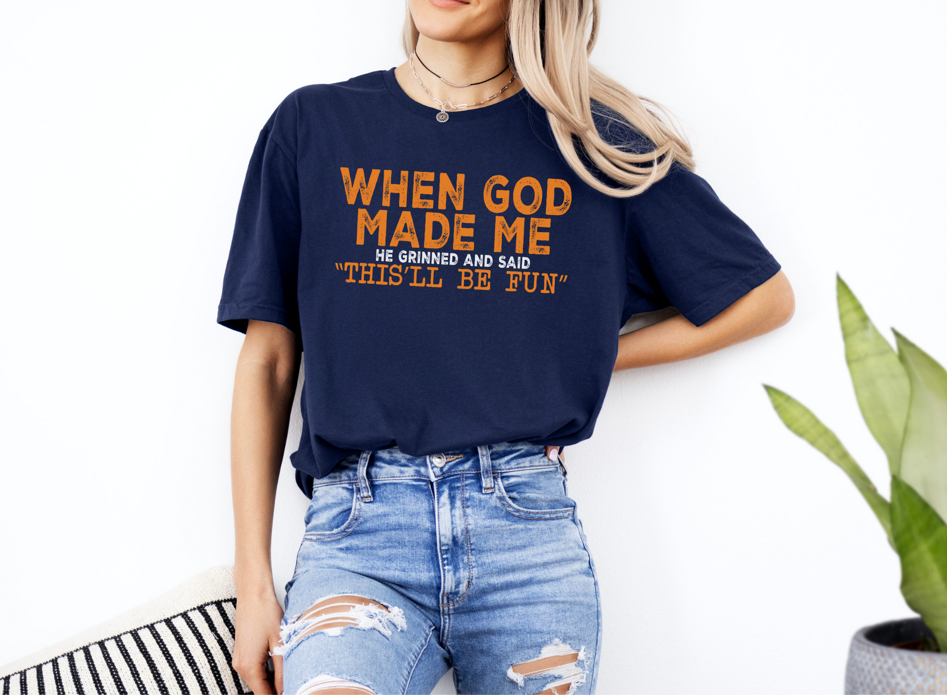 Unisex navy softstyle t-shirt with "When God Made Me He Grinned and Said This'll Be Fun" orange text, casual fit.