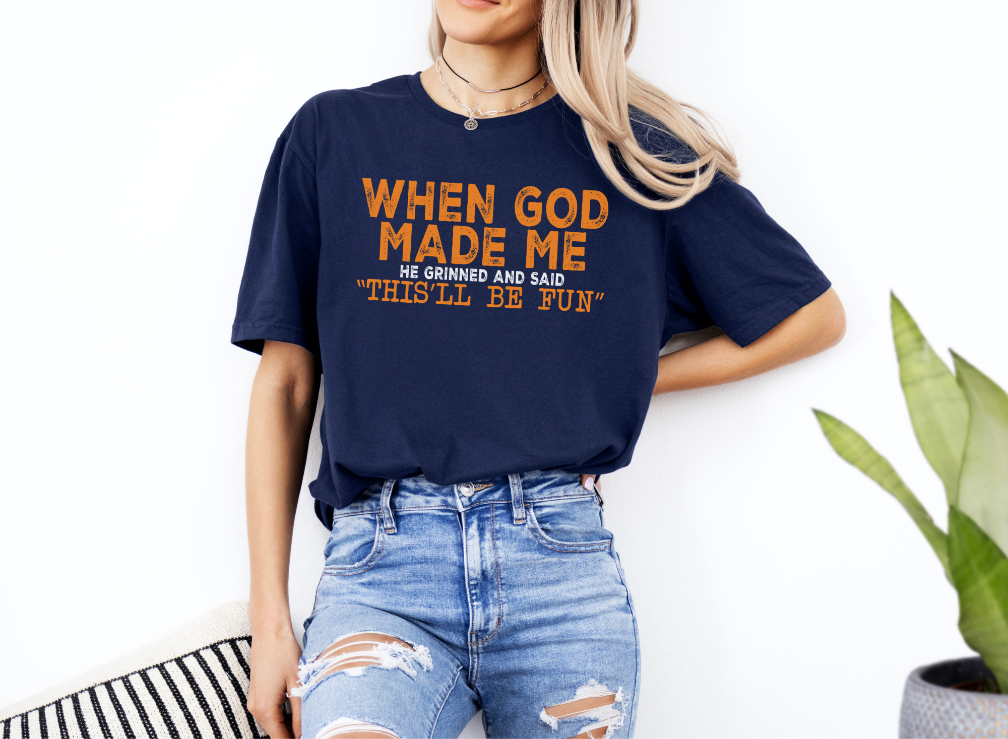 Unisex navy softstyle t-shirt with "When God Made Me He Grinned and Said This'll Be Fun" orange text, casual fit.