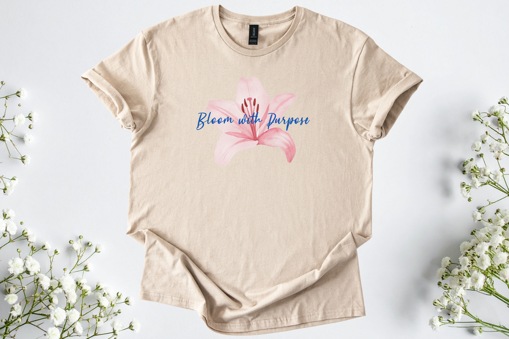 Gildan Softstyle Unisex Shirt in beige with pink flower and "Bloom with Purpose" text, soft and breathable motivational tee