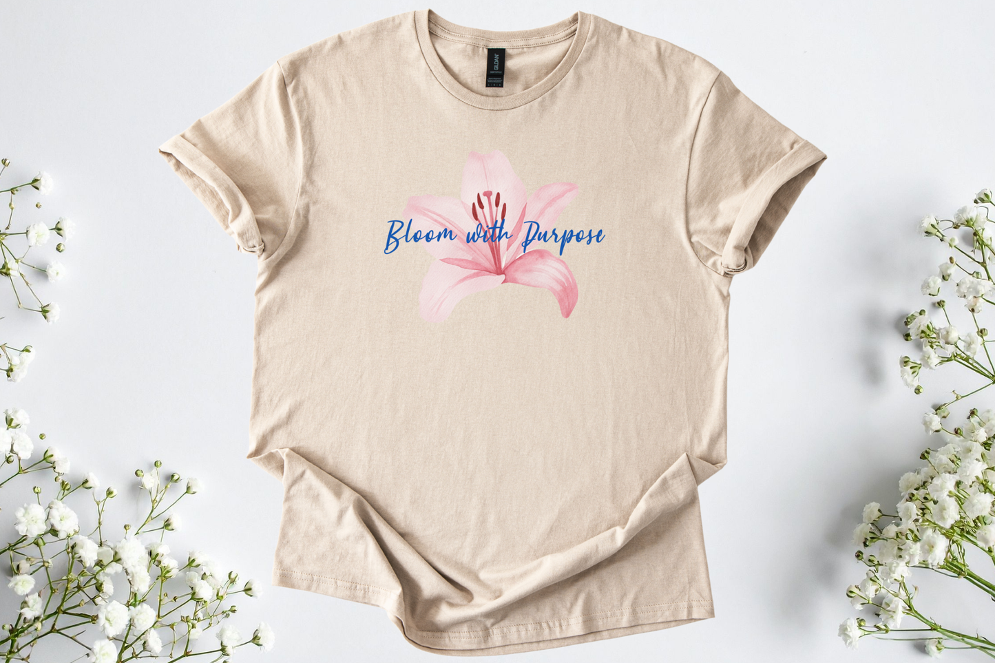 Gildan Softstyle Unisex Shirt in beige with pink flower and "Bloom with Purpose" text, soft and breathable motivational tee