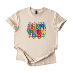 White tee with Autism Mama Rainbow crochet-style yarn lettering and colorful floral accents