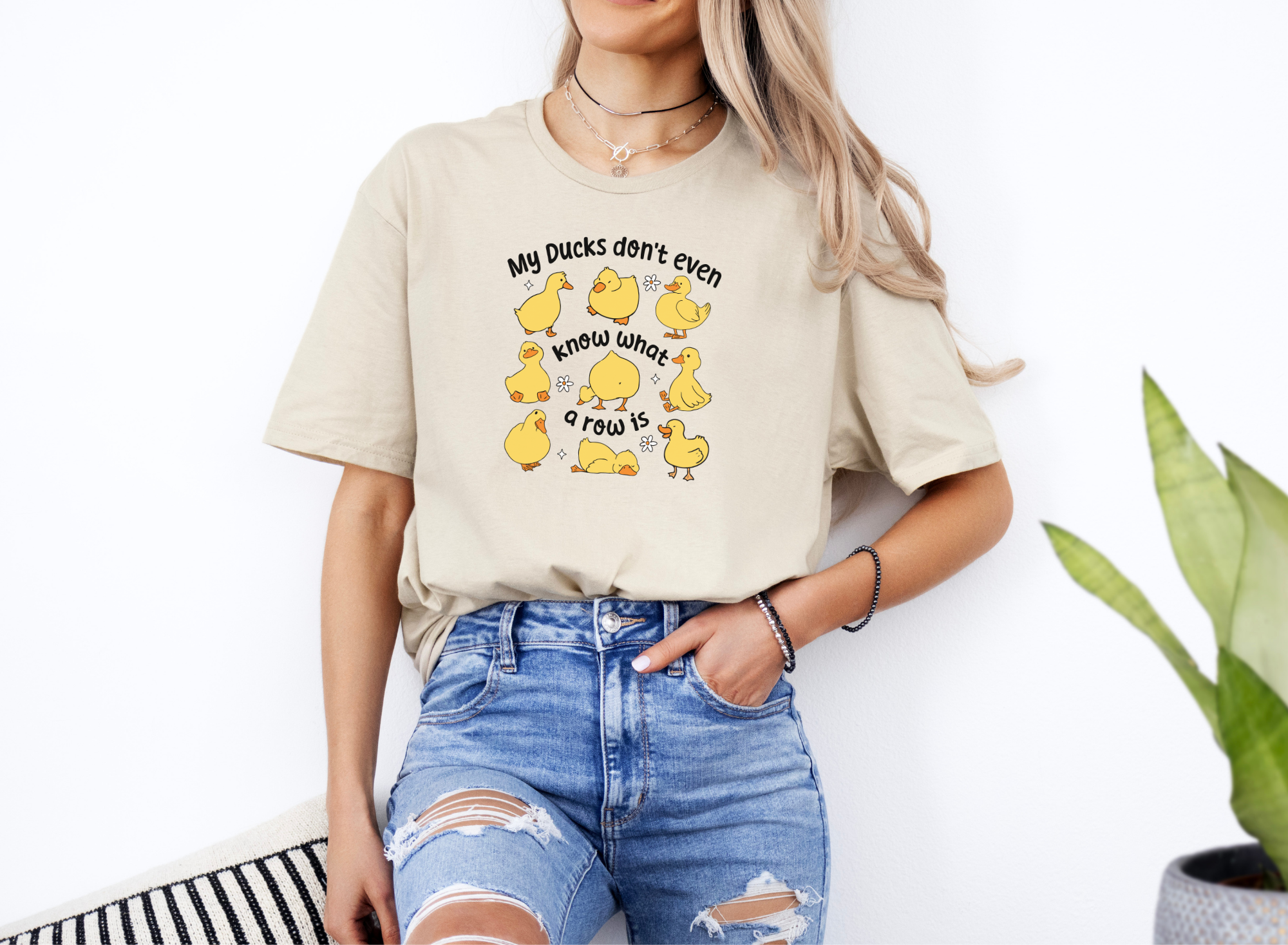 Woman wearing Ducks Not In A Row softstyle short sleeve shirt with cartoon ducks and text design