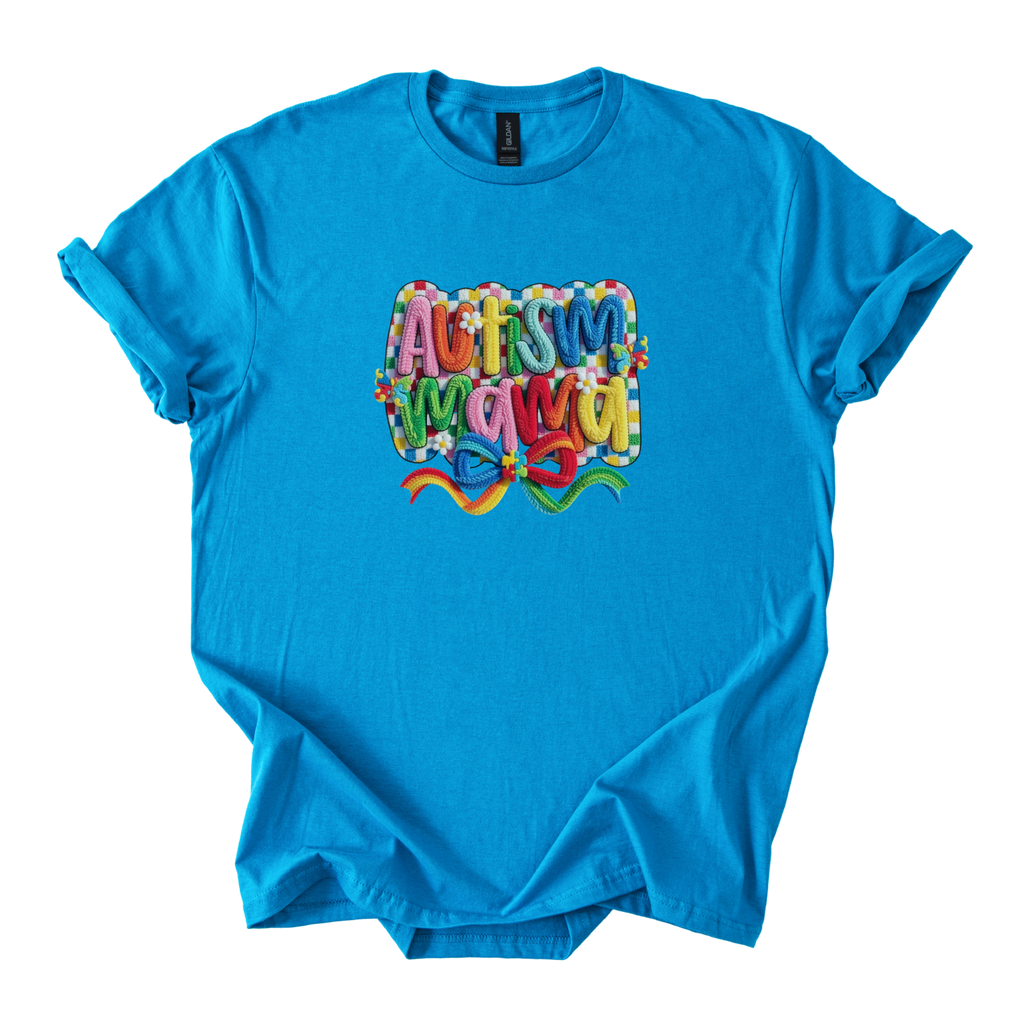 White tee with bold yarn-style Autism Mama Rainbow design and floral accents