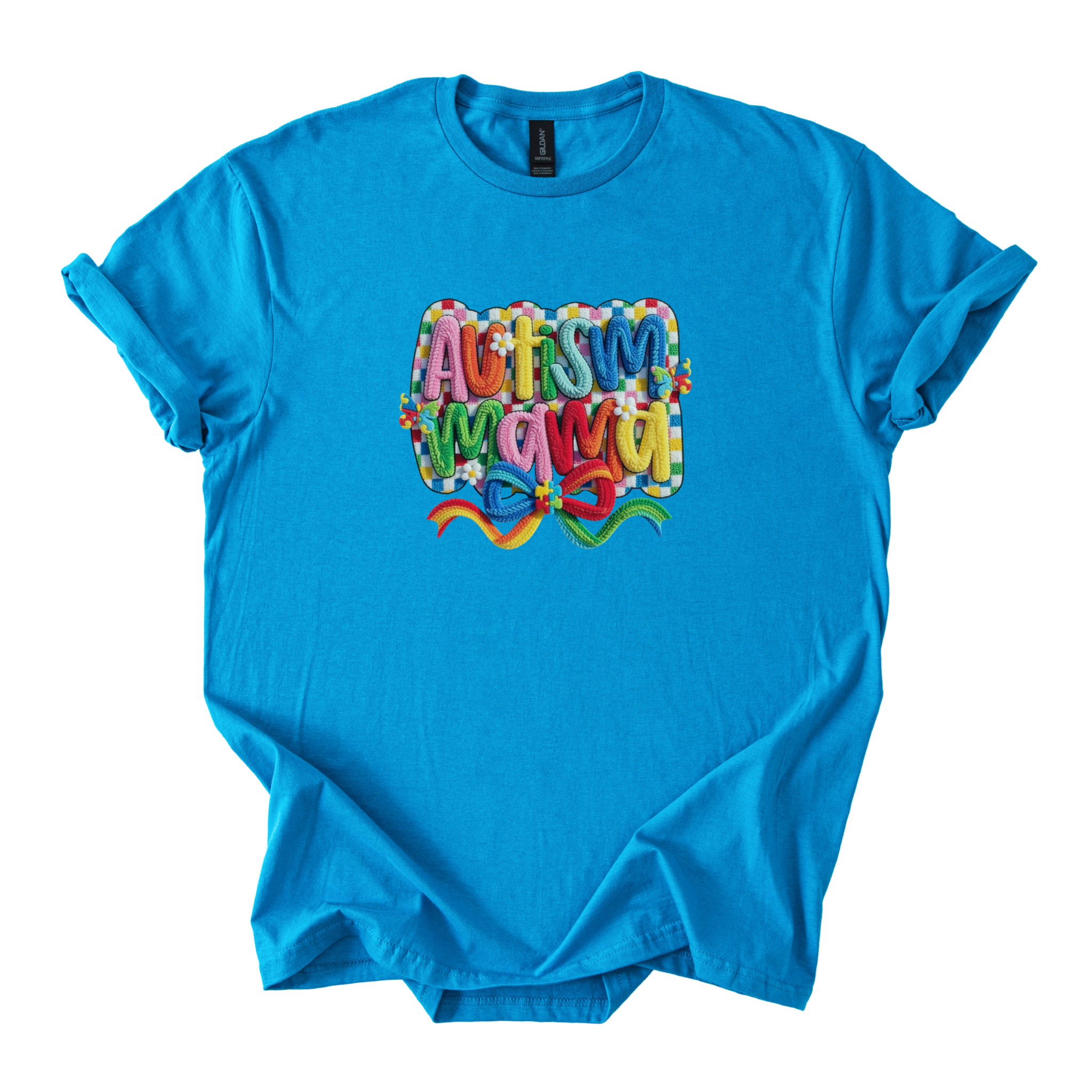 White tee with bold yarn-style Autism Mama Rainbow design and floral accents