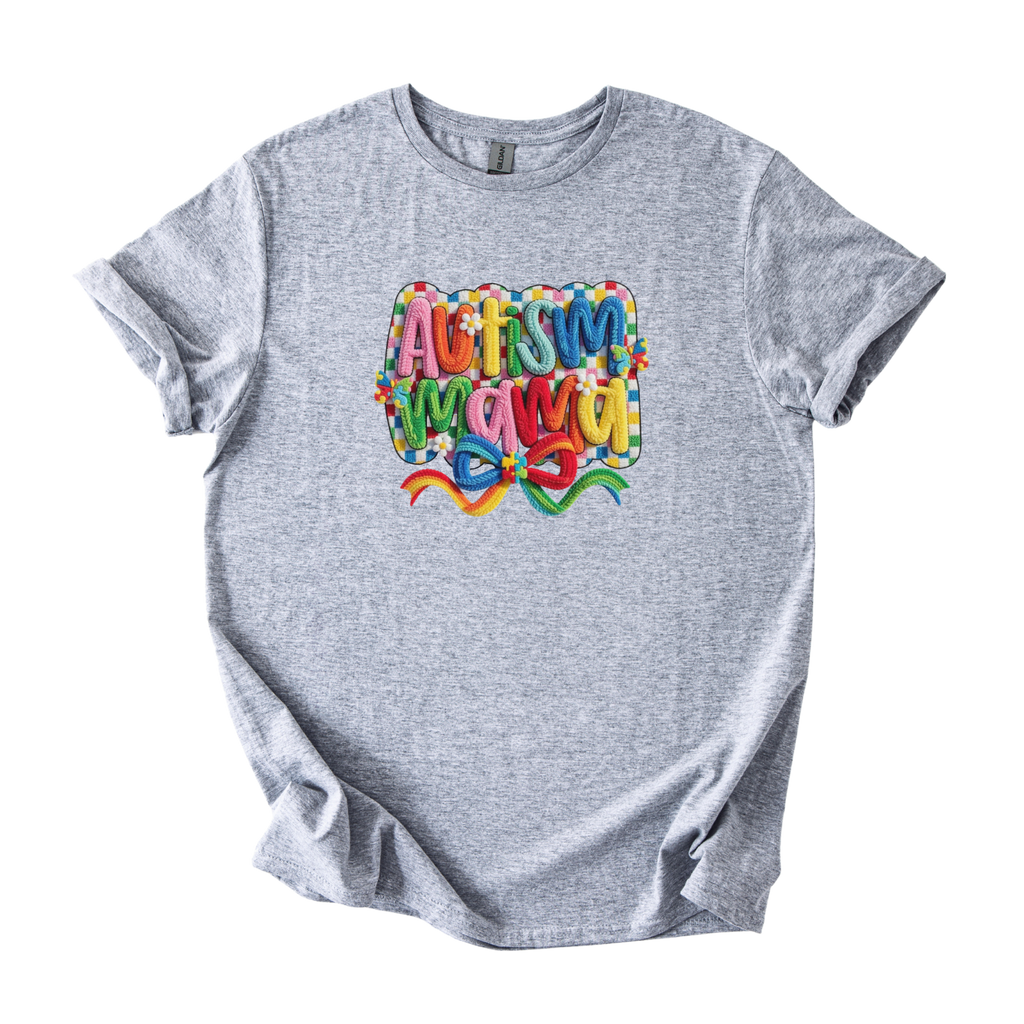 White tee with bold Autism Mama Rainbow yarn-style graphic and colorful floral accents
