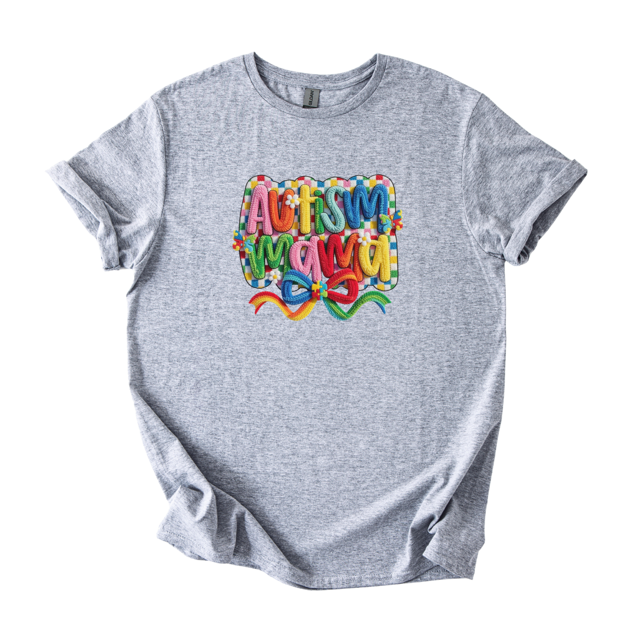 White tee with bold Autism Mama Rainbow yarn-style graphic and colorful floral accents