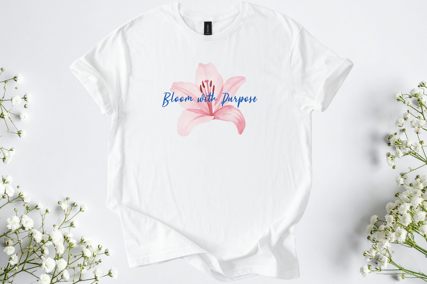 White Gildan Softstyle unisex shirt with pink flower and "Bloom with Purpose" text design