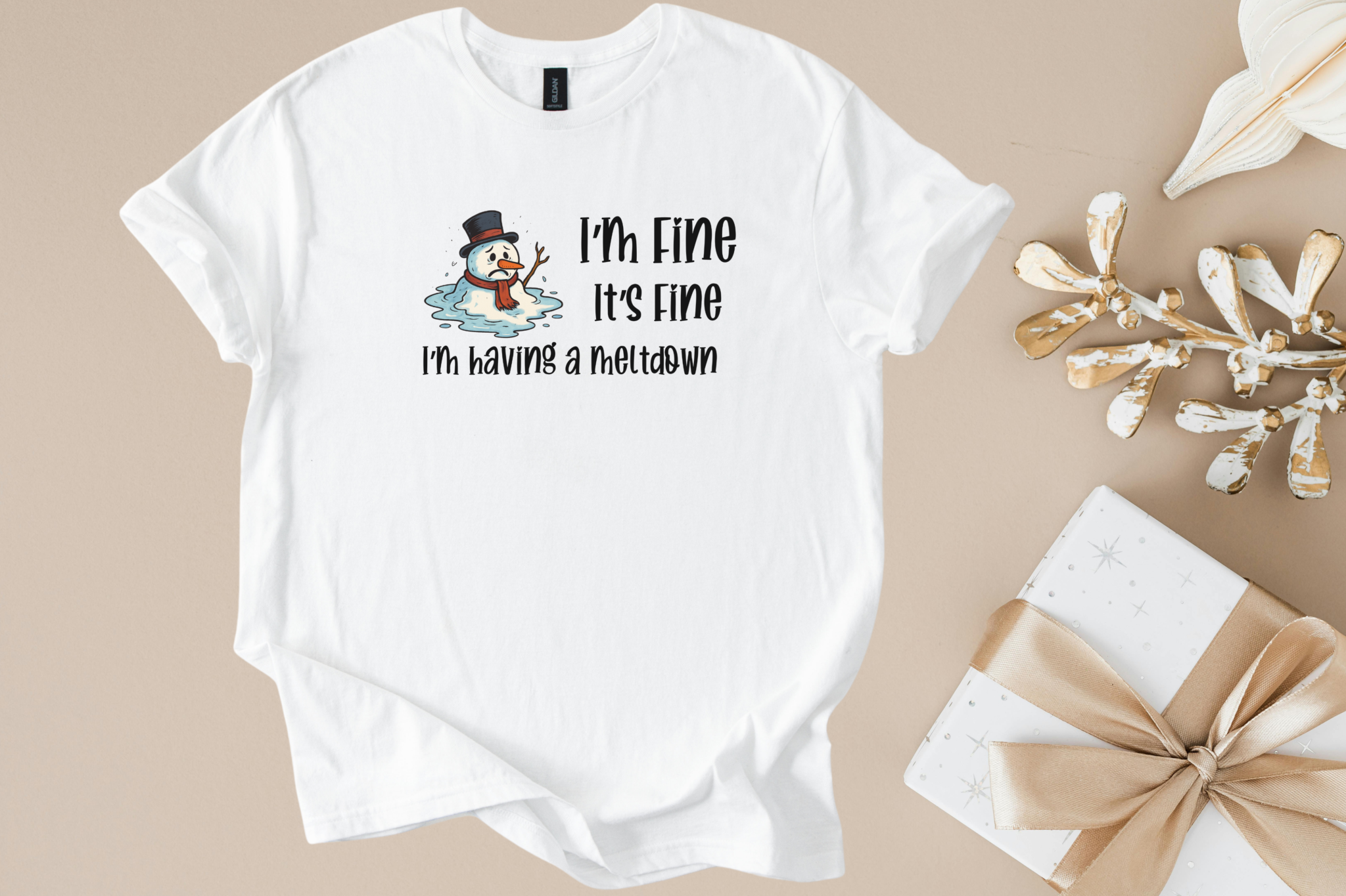 White unisex t-shirt with a melting snowman graphic and "I'm Fine It's Fine I'm having a meltdown" text, holiday humor design